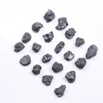 Black diamond with deep dark color displayed in a polished luxury jewelry setting