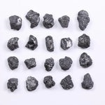 Black diamond with deep dark color displayed in a polished luxury jewelry setting