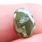 1.55 Ct natural olive green oval cut diamond loose gemstone with visible natural inclusions and faceted surface