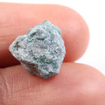 Irregular diamond shape raw diamond stone featuring smooth diamonds areas and rough crystal edges. This rough uncut diamond is perfect for loose diamond buyers