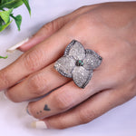 Vintage 4 Petal Pave wedding ring with emerald accents in an Art Deco sterling silver setting.