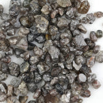 brown grey natural diamond with an untreated rough surface for jewelry creation