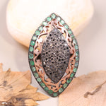 Victorian marquise black diamond ring with an emerald halo in a sterling silver cocktail setting.