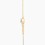 0.18 Ct with gold necklace featuring green gemstone pendant.