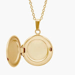 Jade with gold necklace featuring green gemstone pendant.