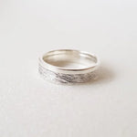 Minimalist sterling silver couple ring set, sleek design ideal for modern partners.