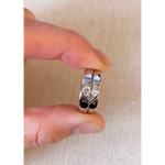 Romantic rose gold couple rings with intertwined hearts, symbol of unity.