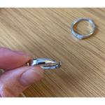 Romantic rose gold couple rings with intertwined hearts, symbol of unity.