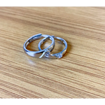 Romantic rose gold couple rings with intertwined hearts, symbol of unity.