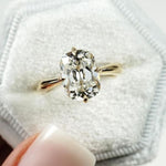 elongated cushion cut diamond ring with twisted yellow gold shank