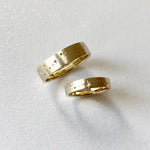 Rose gold couple rings with engraved initials, a romantic personalized gift idea.