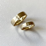 Rose gold couple rings with engraved initials, a romantic personalized gift idea.