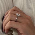 3 carat oval diamond three-stone ring set in polished white gold on a woman’s hand