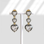 Heart-shaped diamond earrings on a white background