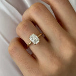 Oval 2 carat diamond engagement ring in white gold displayed on a hand with soft neutral manicure
