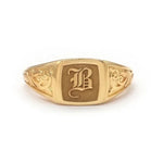 Elegant dainty gold initial ring with custom alphabet engraving in a sleek and stylish signet design