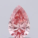 vivid pink colour pear cut pink lab grown diamond with brilliant facets on a light gray background.