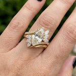 Marquise cut diamond ring with floral side stones in yellow gold