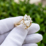 Marquise cut diamond ring with floral side stones in yellow gold