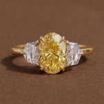yellow oval cut diamond ring with baguette side stones in gold
