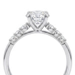 A silver-toned diamond engagement ring featuring a heart-shaped center stone in a prong setting, with small diamonds along the shoulders, shown on a plain white background.