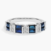 Close-up of 2.64 Ct lab created blue baguette cut gemstone ring with white accent stones on a polished metal band