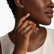 Close-up of 2.64 Ct lab created blue baguette cut gemstone ring with white accent stones on a polished metal band
