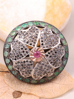 Decorative item with gemstones on a leafy background