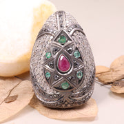Vintage ruby and emerald cocktail ring in antique style silver setting.