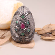 Vintage ruby and emerald cocktail ring in antique style silver setting.