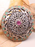 Decorative brooch with gemstones on a leafy background