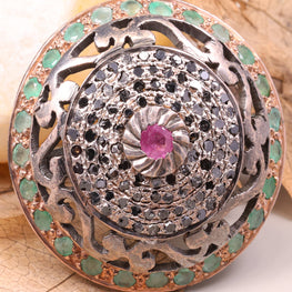 Decorative brooch with gemstones on a leafy background