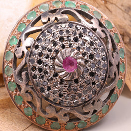 Decorative button with gemstones on a leafy background