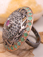 Decorative ring with gemstones on a leafy background