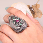 Vintage ruby and emerald cocktail ring in antique style silver setting.