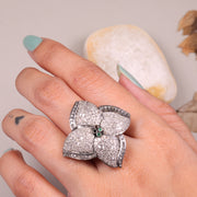 Vintage 4 Petal Pave wedding ring with emerald accents in an Art Deco sterling silver setting.