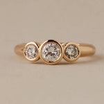2 ct three-stone round brilliant cut diamond ring yellow gold modern engagement ring classic diamond ring vintage diamond earrings 1950s engagement rings