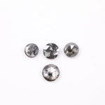 Round brilliant cut lab grown salt and pepper diamond featuring natural black and white galaxy-like inclusions with a faceted surface and translucent gray body tone.