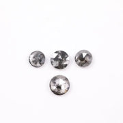 Round brilliant cut lab grown salt and pepper diamond featuring natural black and white galaxy-like inclusions with a faceted surface and translucent gray body tone.