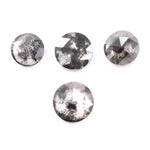 Round brilliant cut lab grown salt and pepper diamond featuring natural black and white galaxy-like inclusions with a faceted surface and translucent gray body tone.