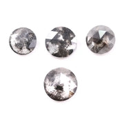 Round brilliant cut lab grown salt and pepper diamond featuring natural black and white galaxy-like inclusions with a faceted surface and translucent gray body tone.