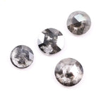 Round brilliant cut lab grown salt and pepper diamond featuring natural black and white galaxy-like inclusions with a faceted surface and translucent gray body tone.