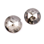Pair of round rose cut lab grown salt and pepper diamonds with smoky gray tone and natural black inclusions, flat back faceting, matching loose stones for custom engagement rings or jewelry design.