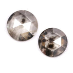 Pair of round rose cut lab grown salt and pepper diamonds with smoky gray tone and natural black inclusions, flat back faceting, matching loose stones for custom engagement rings or jewelry design.