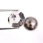 Pair of round rose cut lab grown salt and pepper diamonds with smoky gray tone and natural black inclusions, flat back faceting, matching loose stones for custom engagement rings or jewelry design.