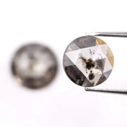 Pair of round rose cut lab grown salt and pepper diamonds with smoky gray tone and natural black inclusions, flat back faceting, matching loose stones for custom engagement rings or jewelry design.