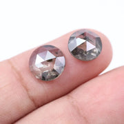 Pair of round rose cut lab grown salt and pepper diamonds with smoky gray tone and natural black inclusions, flat back faceting, matching loose stones for custom engagement rings or jewelry design.