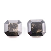 Emerald cut lab grown salt and pepper diamond with geometric step cut facets featuring bold black and smoky inclusions, octagonal shape, ethical sustainable gemstone.