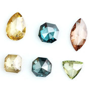 Fancy color diamond lot featuring pear, octagon, marquise and trillion mixed shape loose diamonds ideal for custom fine jewelry design, rings, pendants and luxury gemstone collections.