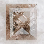 Emerald cut lab grown diamond featuring dramatic salt and pepper style inclusions with natural branching patterns, clear faceting and a unique galaxy-like internal structure.